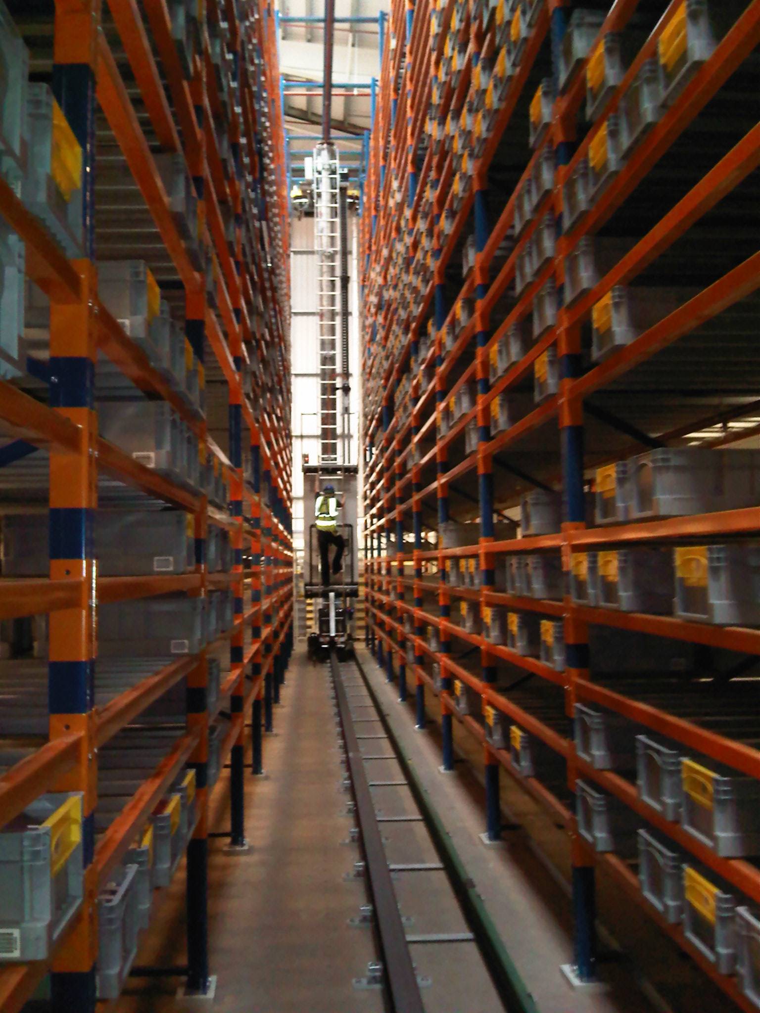 crane rack in operation between tall shelves